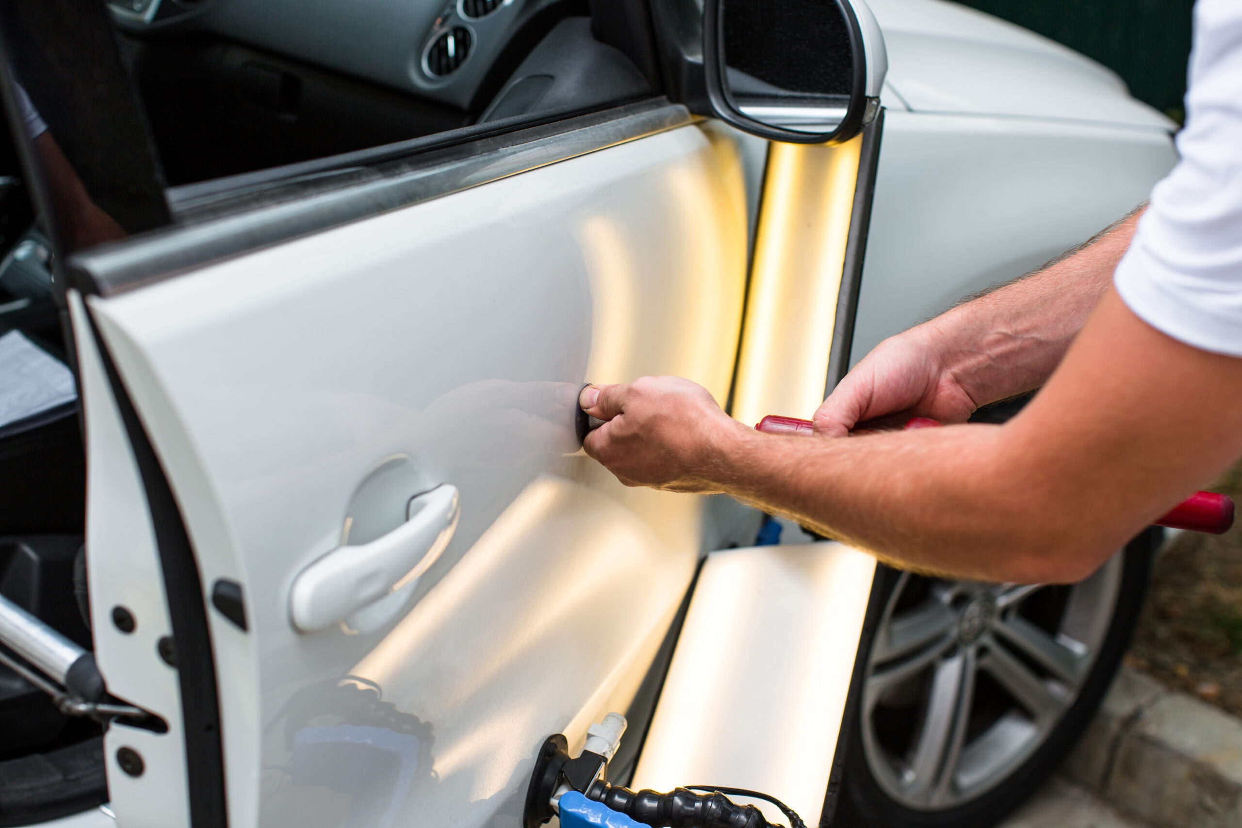 Repairing car dent after the accident by paintless dent repair dent repair